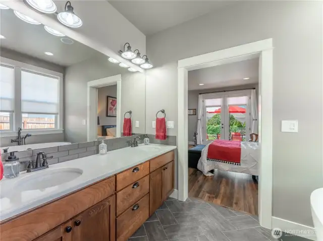 dual sinks with tile backsplash and solid surface countertop