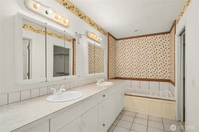 Main floor attached primary bathroom with whirlpool tub & seperate shower
