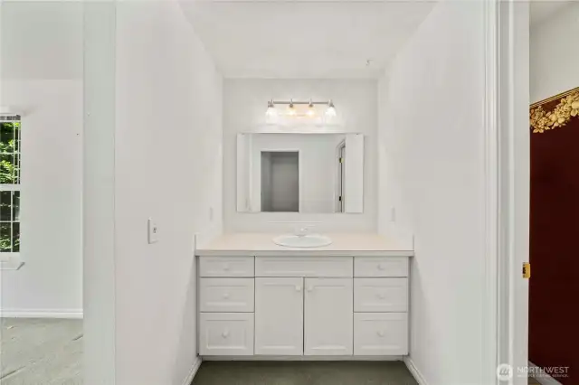 Upper primary bathroom vanity adjacent to bathroom and closet