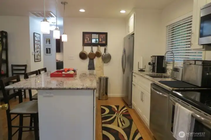 Kitchen to hallway toward bathroom and two bedrooms.