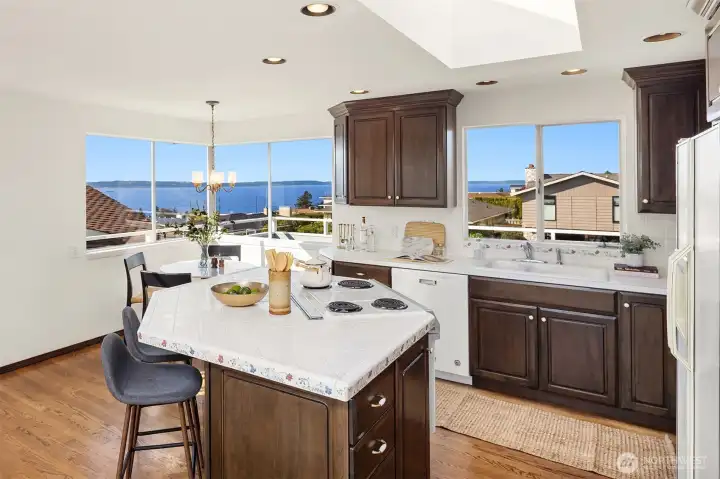 Kitchen with hardwood floors, skylight, island, and amazing views.