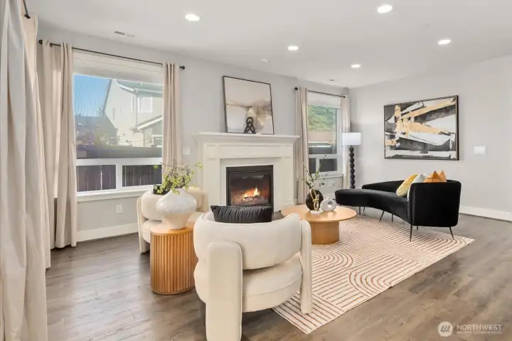 Living room featuring built-in speakers, tinting on windows, and gas fireplace.