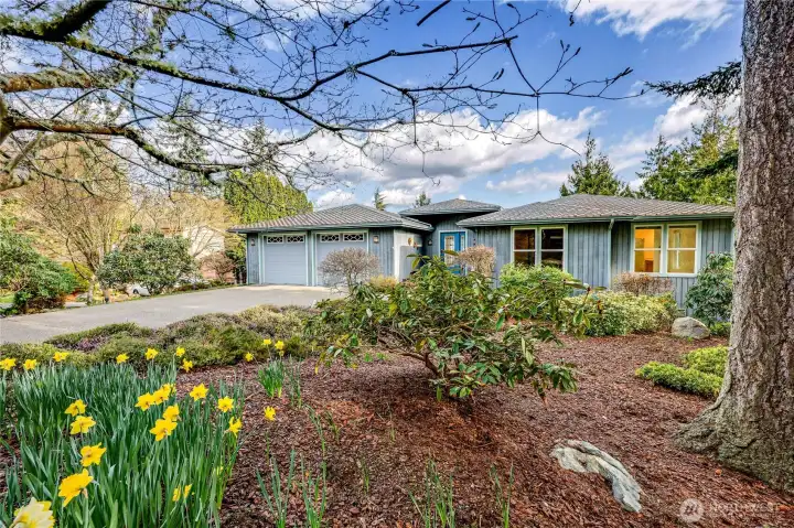 Lovely landscaping surrounds the home.