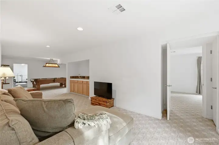 Lower level rec room.  Door to bedroom suite is  straight ahead.