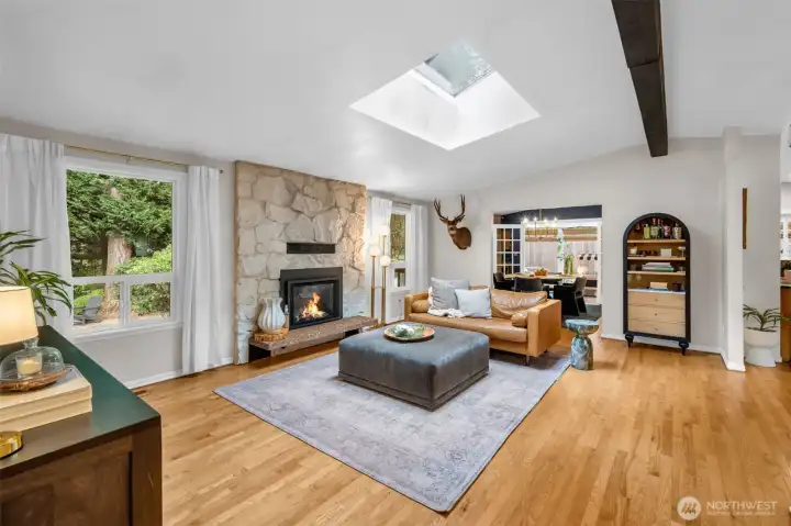 Vaulted ceilings, oversized skylights, shining hardwood floors & rustic beams are all features of the open concept great room.