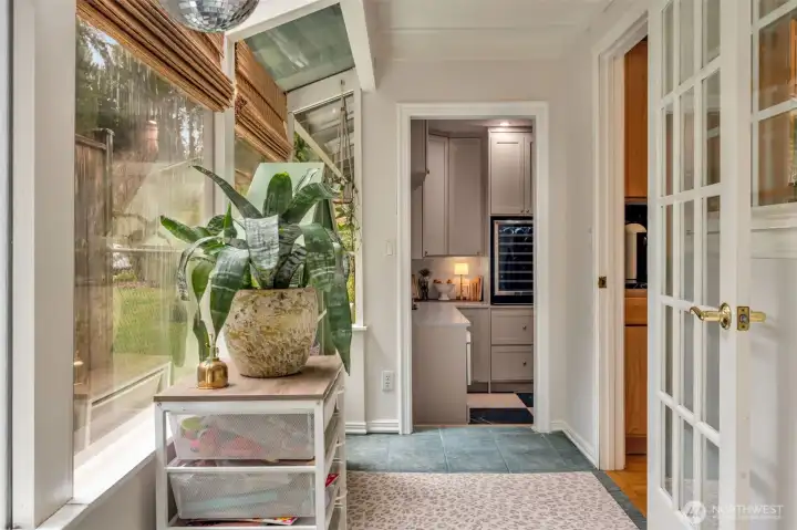 Sunroom, running the entire length of the kitchen, filled with bright light and NEW windows. A perfect play space, yoga room or reading nook.