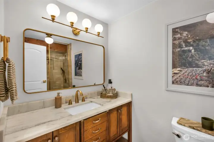 Hallway bath, refreshed to offer the same luxurious feel as the entire home exudes.