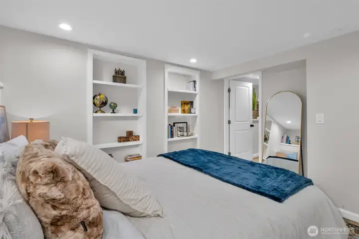 This bedroom offers great light, build in shelves & a custom closet.