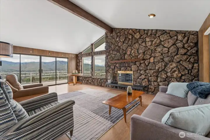 Open great room with tons of windows taking advantage of the view