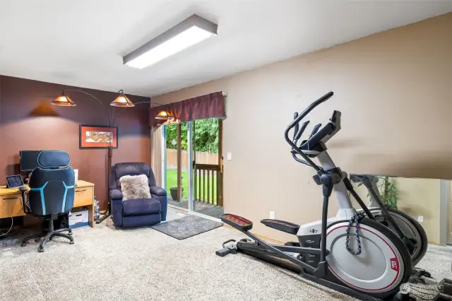 Extra living / TV / Office / fitness room downstairs with entry from garage.