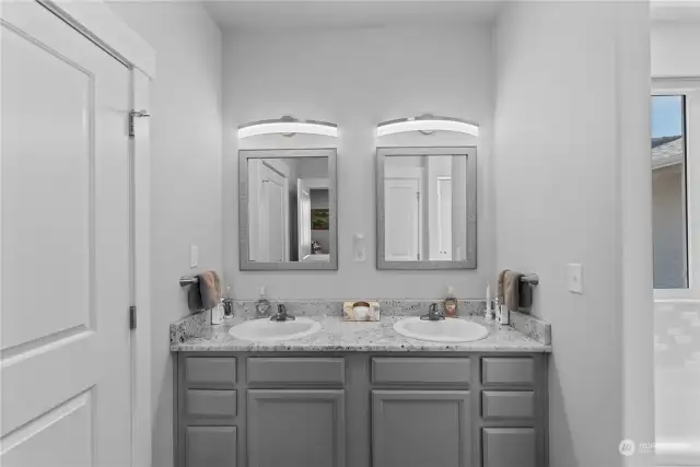 Primary bath with double vanity, soaking tub, and separate shower