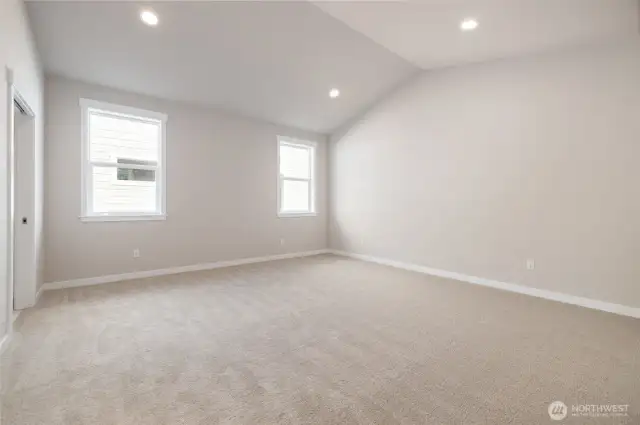 The primary bedroom has vaulted ceilings.