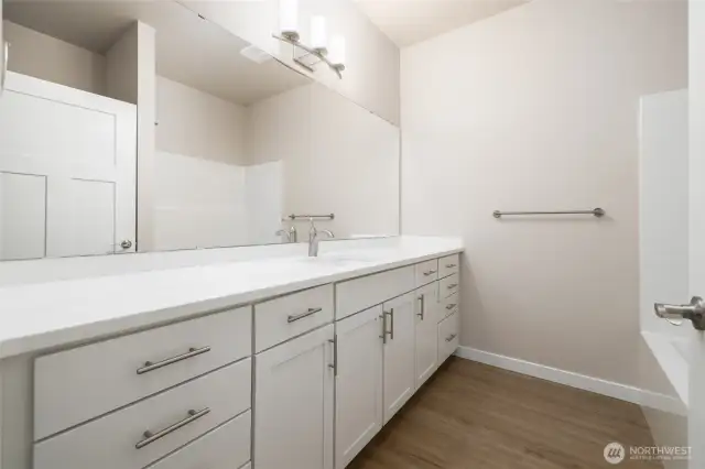 The main bath has lots of counterspace, taller cabinets & quartz counters.