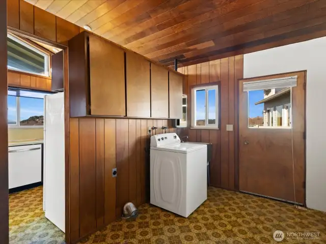 Laundry is located back to back with the kitchen. Note, the T&G ceiling continues through .