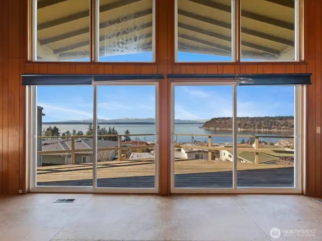 Great room double sliders to covered deck frame the view