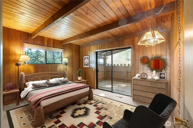 Primary bedroom has door accessing deck and hot tub