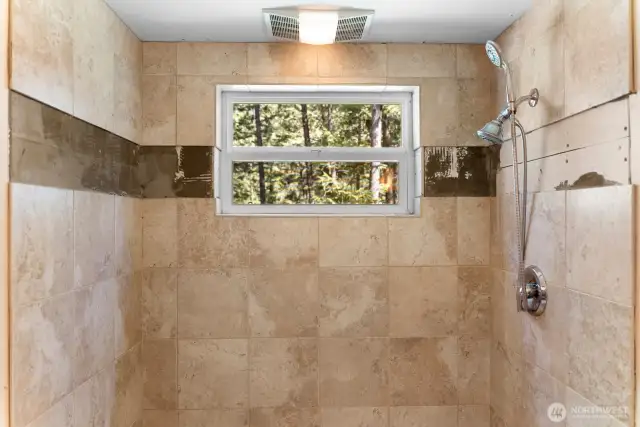 Beautiful tile shower. The strip that is missing tiles is not damaged, it has just been left for you to bring your own creative flare...