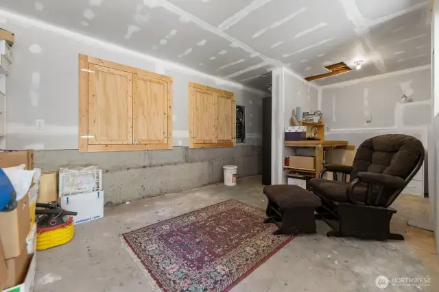 Behind those wooden doors are the water heater and pressure tank. It's clean and well lit, and great for long term food storage, wine storage, etc.