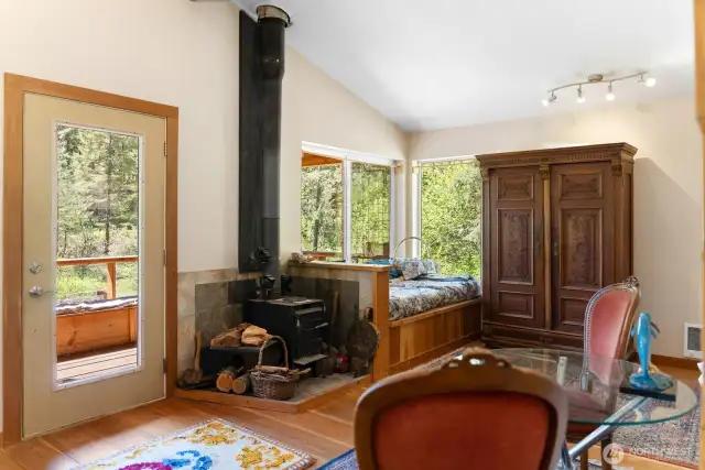 The built-in day bed is also a box for wood storage, with an access door on the exterior of the cabin. Or use it to store other items. The large oak armoire stays with the sale.