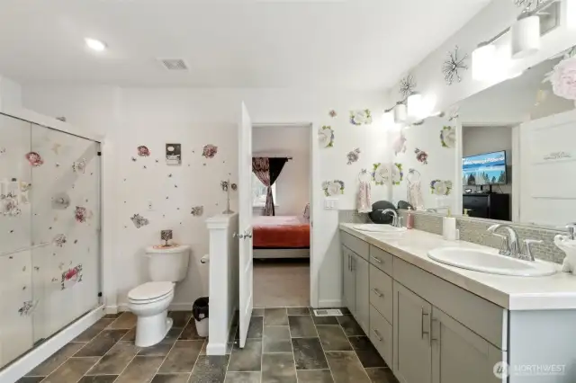 Primary bathroom with walk in shower, double vanity and soaking tub