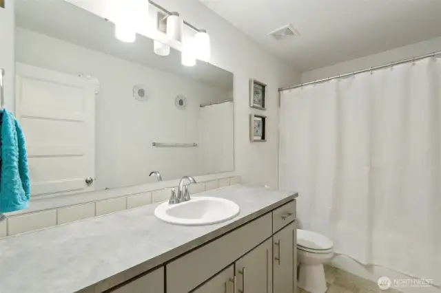Upstairs bathroom with tub and shower