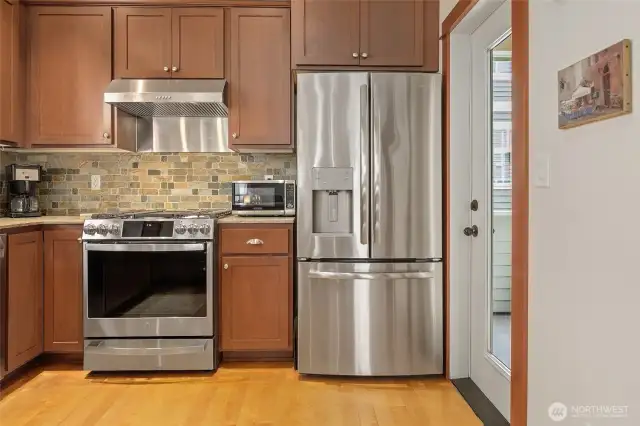 Classy and timeless kitchen with stunning stainless steel appliances.