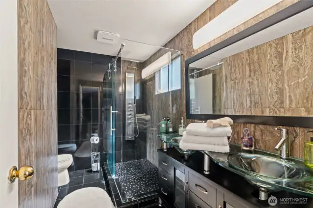 Luxuriously updated bathrooms showcase high-end tile work and modern finishes—renovated in recent years with attention to both style and quality