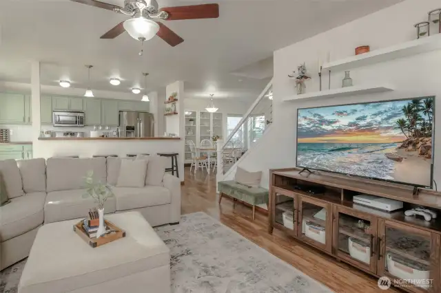 The living room offers a cozy yet comfortable retreat, located just off the kitchen for effortless connection and everyday living.
