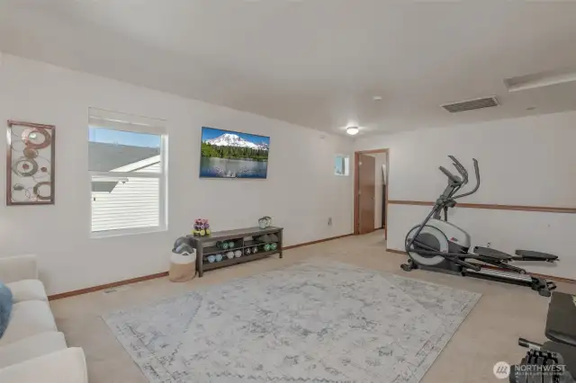 The bonus area offers access to all three bedrooms and the hallway bathroom, with plenty of natural light filling the space—perfect for a variety of uses!