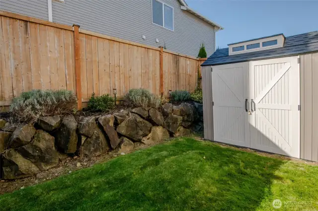 Tucked into the corner of the yard, the spacious shed provides ample storage for lawn equipment, gardening tools, seasonal decorations, outdoor furniture, and more—keeping your backyard organized and clutter-free.
