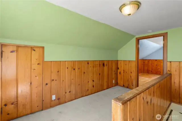 Landing area at top of stairs, connects to primary bedroom.