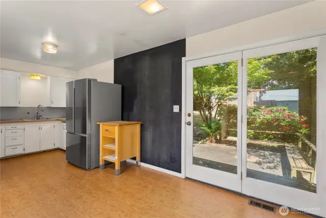 Spacious kitchen and dining area, opens to tastefully landscaped back yard.