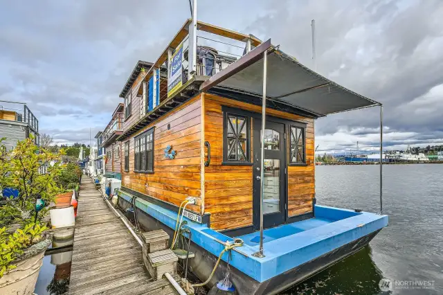 As you walk down the dock to this Seattle houseboat 28' X 10' dimensions with a rooftop deck overlooking the Ship Canal  you will see why this lifestyle is so important to your soul.