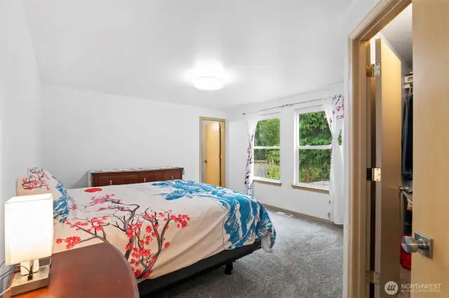 Find comfort in this spacious bedroom, a quiet sanctuary from the day's hustle.