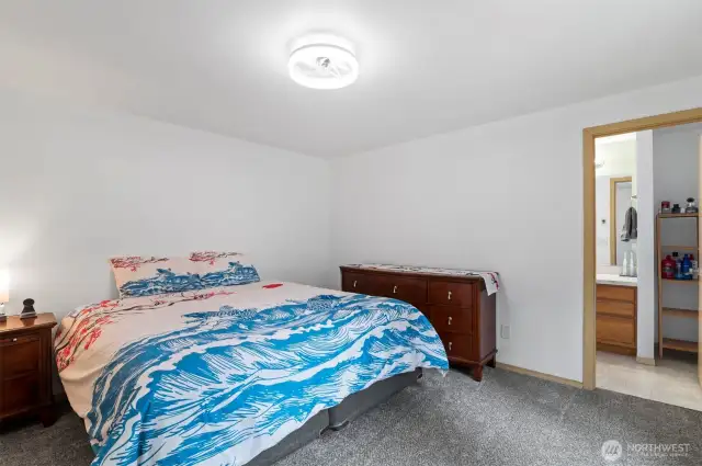 Your private retreat. Unwind in this peaceful primary bedroom with new carpeting and a serene atmosphere.
