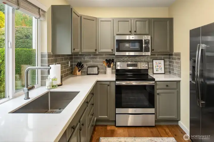 Kitchen with new countertops, back splash, and appliances