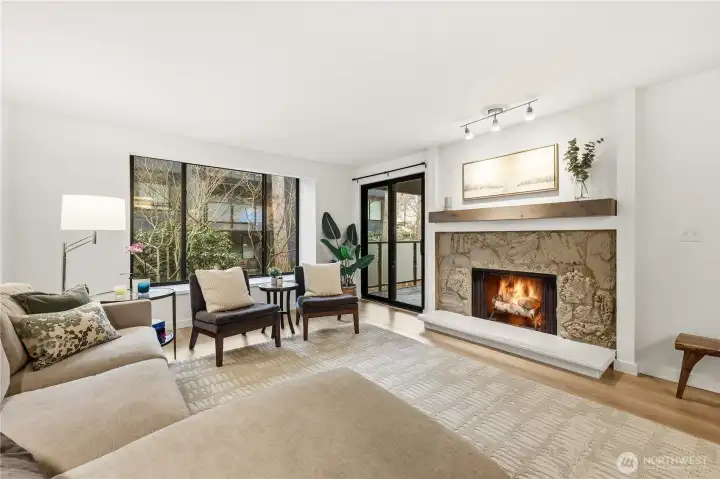 Living room with large window to garden and wood fireplace