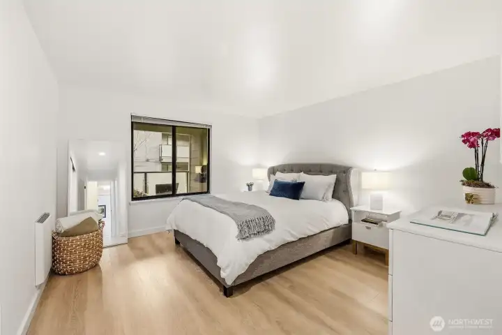 Primary bedroom with window to balcony