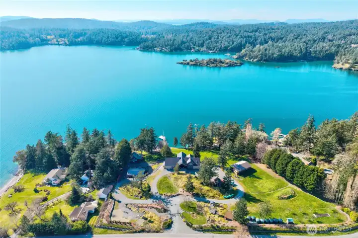 Twin Coves at midday, showcasing the protected bay and nearby Skull Island Park—just a short kayak trip away, with ample space on the property for gardening, a greenhouse, or expanded growing areas