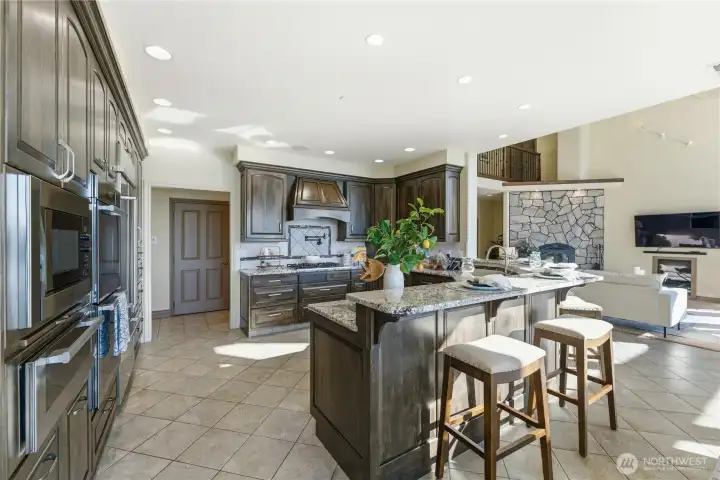 Well-appointed kitchen with multiple ovens, main dishwasher, and a 6-burner gas range complete with RO pot filler