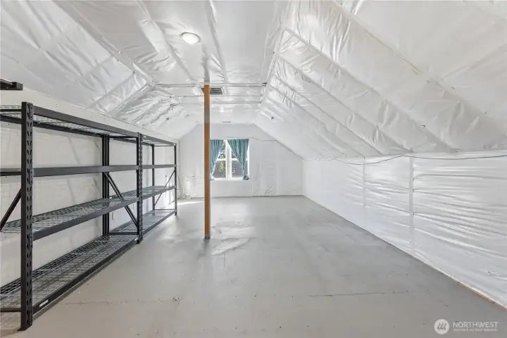 The south bedroom suite is drywall-ready, with plumbing in place for a bathroom and framing for a large dormer. Behind the drywalled left wall lies extensive built-in storage