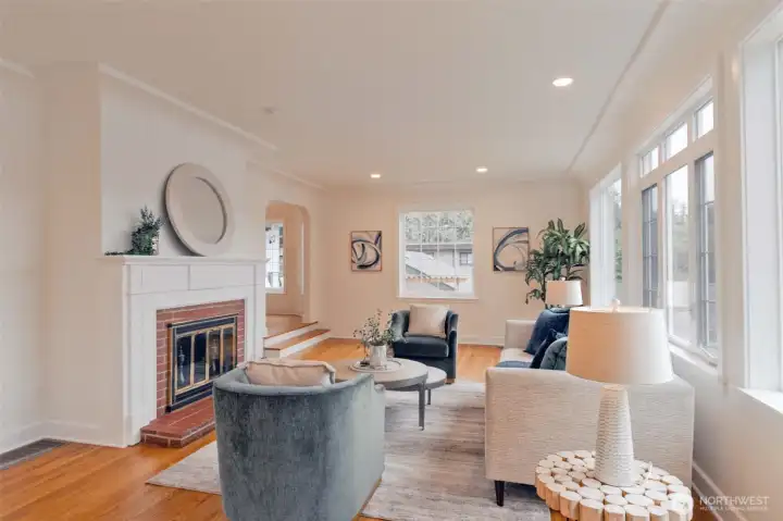 Coved ceiling, oak hardwood floors in welcoming living room. The Olympic mountains can be seen from this room on clear days, what a treat!