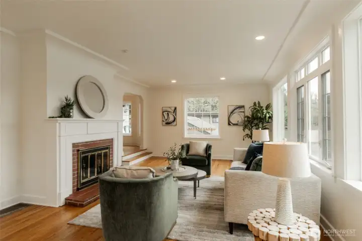 Coved ceiling, oak hardwood floors in welcoming living room. The Olympic mountains can be seen from this room on clear days, what a treat!