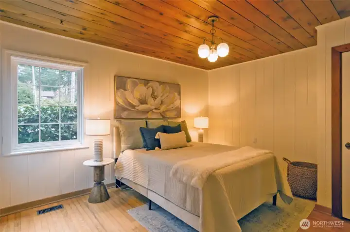 Oak hardwood floors and garden views from main floor bedroom