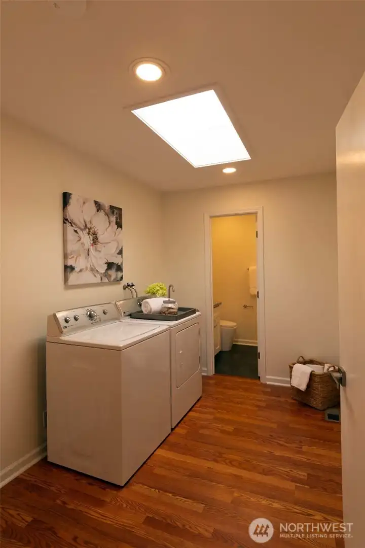 Spacious mudroom with utility sink, access to 2 car garage