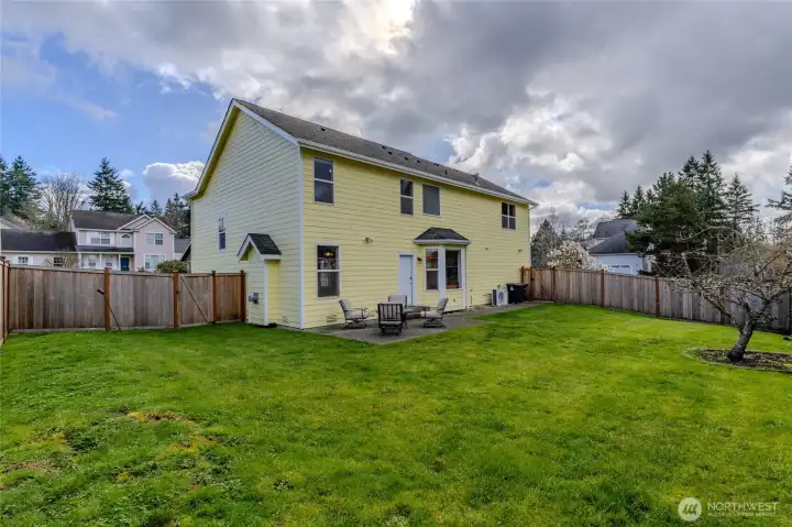 Spacious, fully fenced back yard with patio space and conveniently located exterior door into the great room.