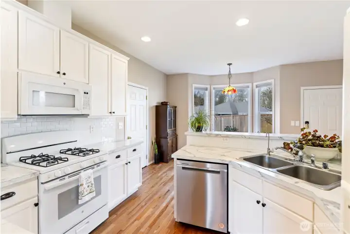 Very efficient & functional eat-in kitchen, with doors to both the garage on left and back yard on the right.