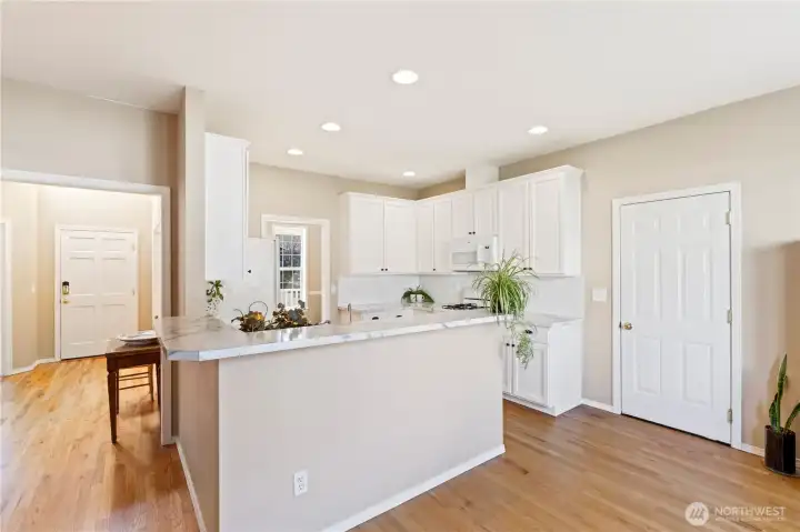Kitchen also has an eating bar and doorway to a formal dining room. Door on right to the attached 2 car garage.