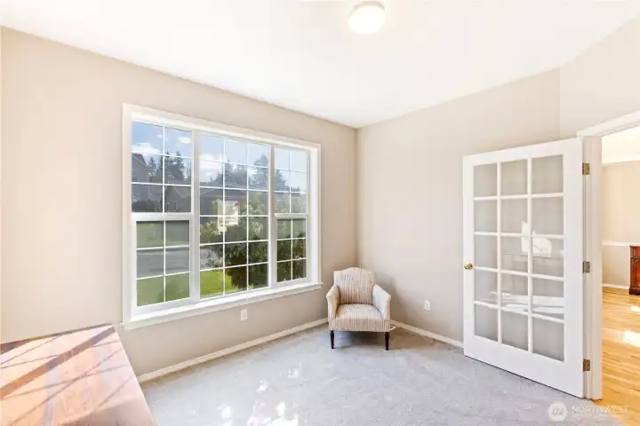 Den/office looking toward front foyer into formal dining room.,
