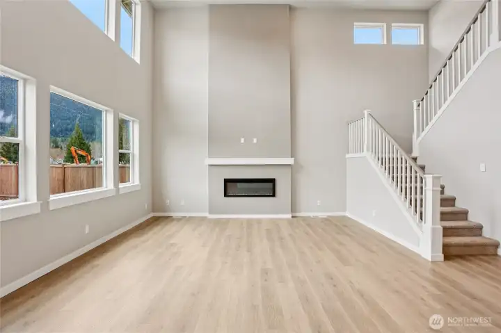 Soaring ceilings in the living room allow for ample light.  Photos are for representation purposes only.  See agent for details.